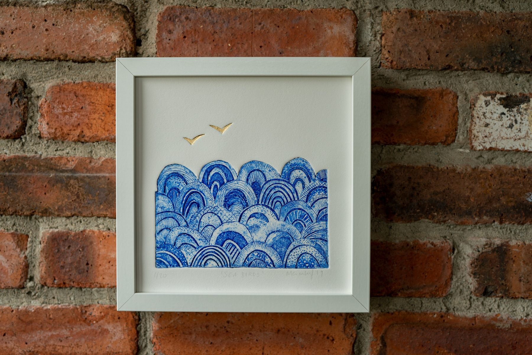 A blue and gold bird print by Marian Haf
